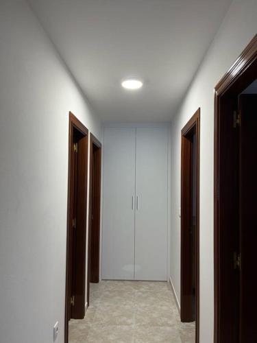 an empty hallway with two open doors and a room with at Apartamentos Vive Laxe in Laxe