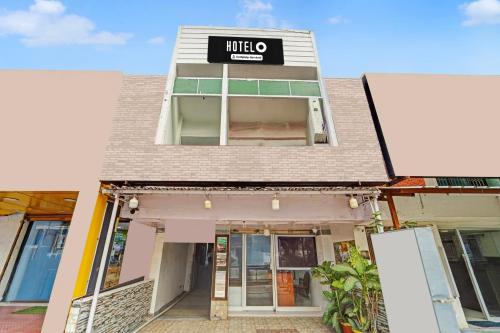 a building with a hotel sign on top of it at Super Hotel O Erode Bus Stand in Erode