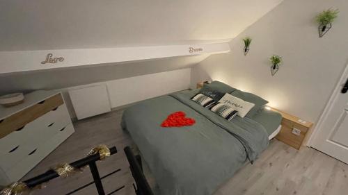 a bedroom with a bed with a red heart on it at Luana SPA Boussois in Boussois
