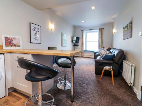 a living room with a bar and a couch at Flat 2, Dorstan in Carnforth