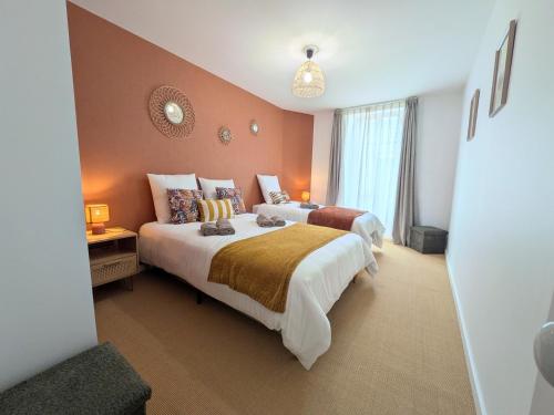 a hotel room with two beds and a window at Laroseliere in Mauléon