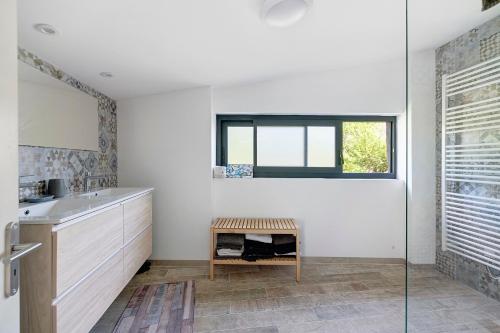 a bathroom with a sink and a window at Gite Les 3 Tilleuls in La Ville Dieu du  Temple