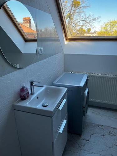 a bathroom with a sink and a mirror at City Center Szczytno III in Szczytno