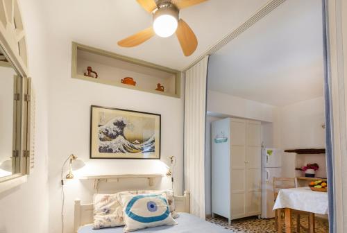 a bedroom with a ceiling fan and a bed at Bougainvillea House in Parikia