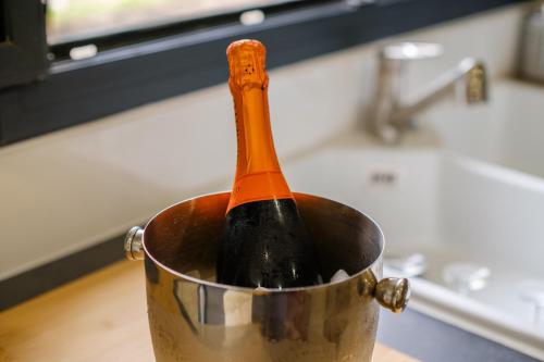 a bottle of wine in a pot on a kitchen counter at Villa Cyprès Bleu in Peymeinade
