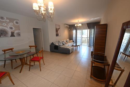 a living room with a table and a couch at 50 meters to the beach 3 bedroom appartment in Limassol