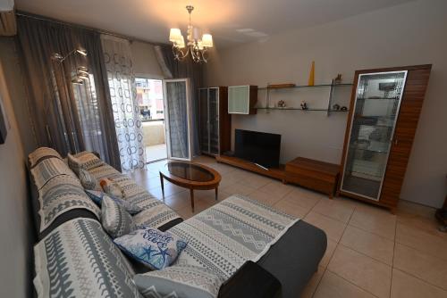 a living room with a couch and a tv at 50 meters to the beach 3 bedroom appartment in Limassol