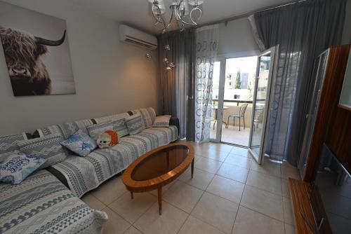 a living room with a couch and a table at 50 meters to the beach 3 bedroom appartment in Limassol