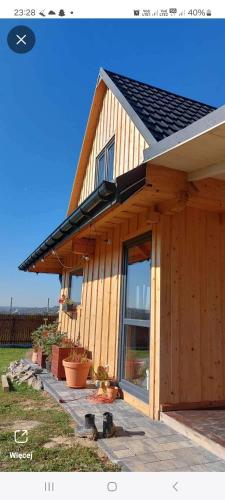 a house with a solar roof on top of it at Dębowa Chata in Jasło
