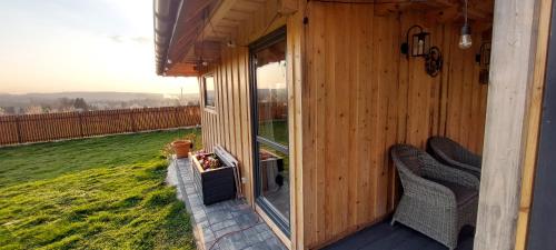 a wooden cabin with a balcony with a window at Dębowa Chata in Jasło