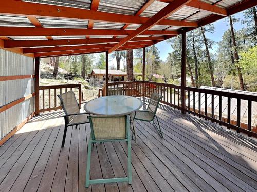 a table and chairs on a wooden deck at A Step Above in Ruidoso