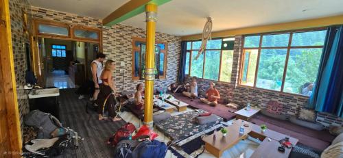 a group of people sitting in a room at House of Brahma Kasol in Kasol