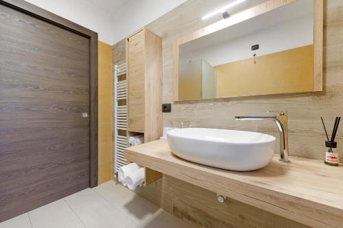a bathroom with a white sink and a mirror at Appartamenti Suly 3 - Cir0084 in Saint Vincent