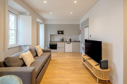 a living room with a couch and a kitchen at CapeTown Marula 1BR apartment in Caparica