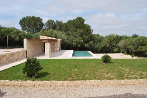 a house with a swimming pool in a yard at Luxury Villa Son Mas in Manacor