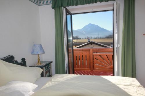 a bedroom with a bed and a view of a mountain at Hotel Sonnenhof - bed & breakfast & appartements in Innsbruck