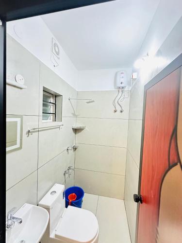a bathroom with a toilet and a sink at Castle villa in Cochin