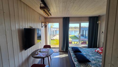 a room with a couch and a table and a television at Central Riverside Apartments in Jēkabpils