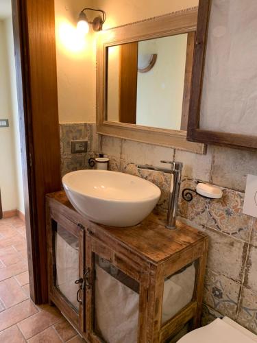 a bathroom with a white sink and a mirror at Ancient townhouse next castle in Vezzano Ligure