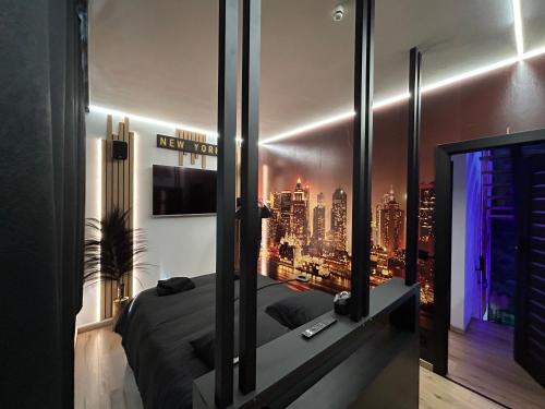 a bedroom with a view of a city at Maison 3 chambres, jacuzzi, billard, sauna, air soccer, clim in Verviers