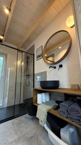 a bathroom with a tub and a sink and a mirror at Stodoła Dębki in Dębki
