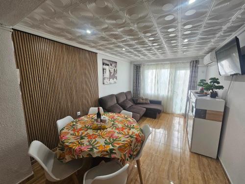 a living room with a table and a couch at MarDeSantaPola in Santa Pola