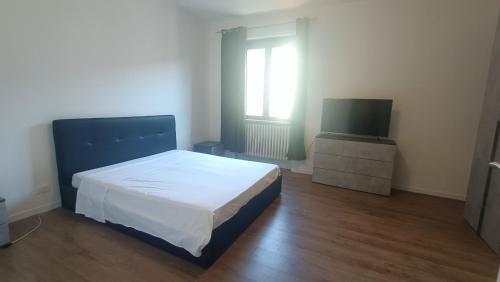 a bedroom with a bed and a flat screen tv at Molino in Pavia