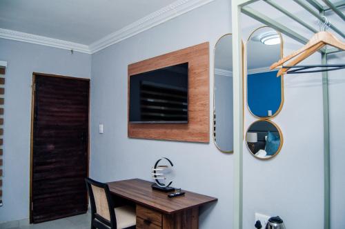 a dining room with a wooden table and a mirror at Overflow Accommodation Lodge in Louis Trichardt