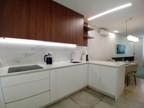 a kitchen with white cabinets and a counter top at Da Valeta Ó in Arcos de Valdevez