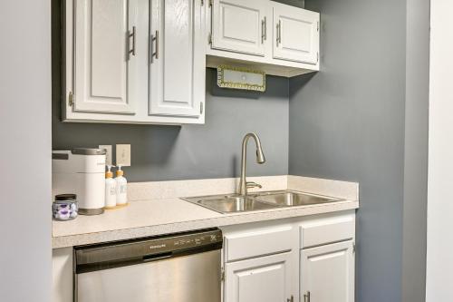 a kitchen with white cabinets and a stainless steel dishwasher at Mountain Maryland Adventures Await in McHenry