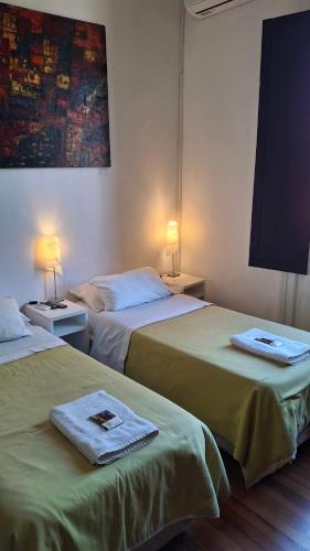 a hotel room with two beds with towels on them at Balcones de Cabrera in Buenos Aires