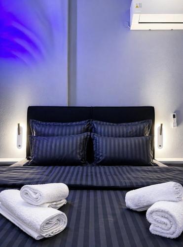 a bedroom with a bed with towels on it at Sountou home in Xanthi