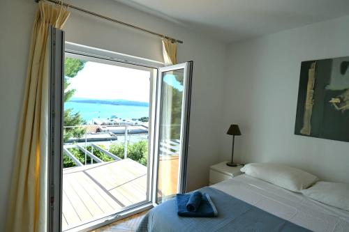 a bedroom with a bed and a large sliding glass door at Adriatic Breeze in Hvar