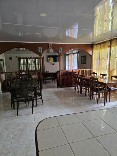 a dining room with wooden tables and chairs at Hostal Las Molas in Volcán