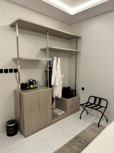 a room with a closet with a chair in it at Bee House in Taif