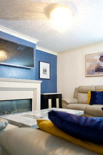 a living room with a couch and a fireplace at The Bank in West Derby