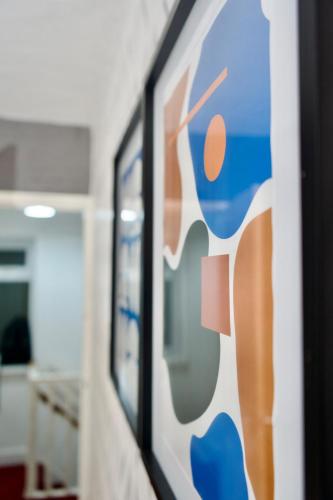 a wall in an office with a painting on it at The Bank in West Derby