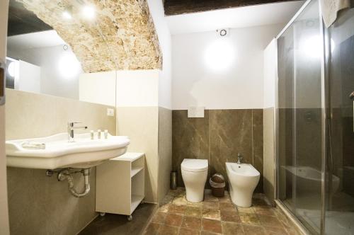 a bathroom with a sink and a toilet at BIANCA ROOMS in Noto