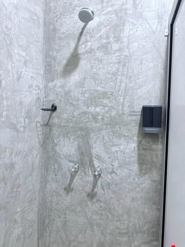 a shower with a reflection of a tennis racket at Casa Xolococo in Brisas de Zicatela