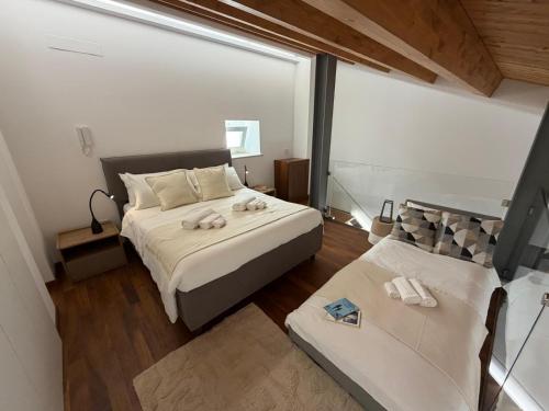 a bedroom with a large bed and a couch at Donna Dina in Avola