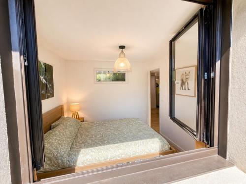 a bedroom with a bed and a large mirror at La Skibelle Orelle-ValThorens- Sauna & bain nordique in Orelle