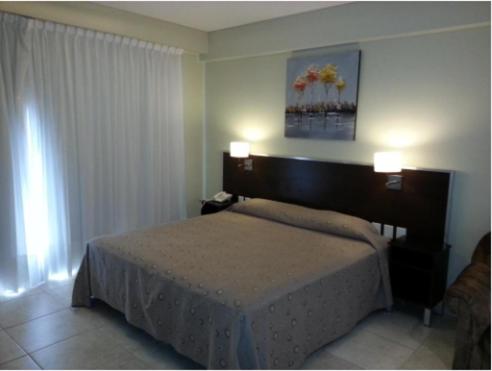 a bedroom with a bed with two lights on it at Hotel Nontue Abasto Buenos Aires in Buenos Aires