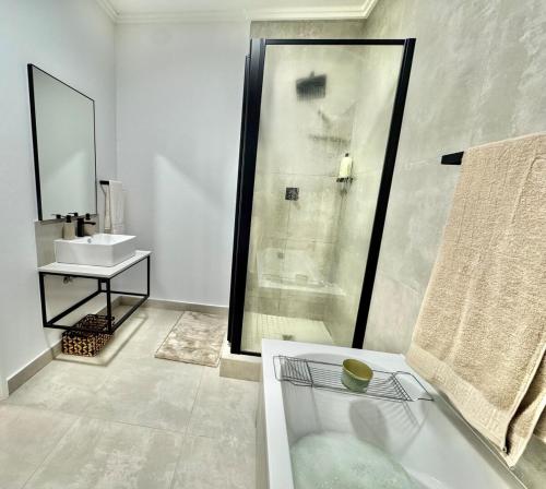 a bathroom with a shower and a sink at The Gentle Abode in Sandton