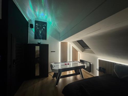 a room with a ping pong table in the ceiling at Maison 3 chambres, jacuzzi, billard, sauna, air soccer, clim in Verviers
