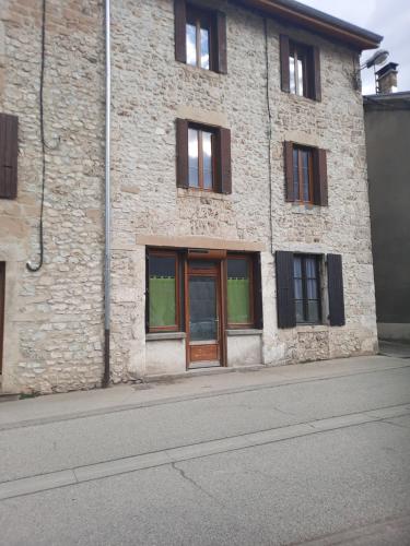 a brick building with a door on the side of it at les ruffins in Saint-Jean-en-Royans