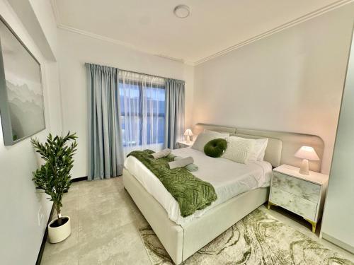 a white bedroom with a large bed and a window at The Gentle Abode in Sandton