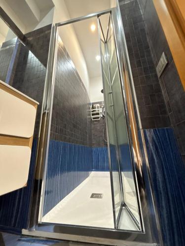 a shower with a glass door in a bathroom at B&B Fiore di Maggio in Mola di Bari