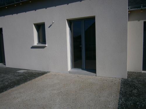 a white building with a window on the side of it at Chez Elisa in Chinon