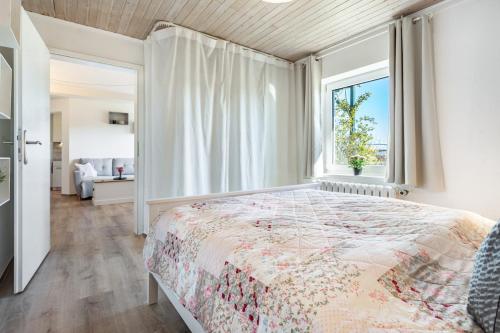 a bedroom with a large bed and a window at Ferienwohnung Wulf in Groß Zicker