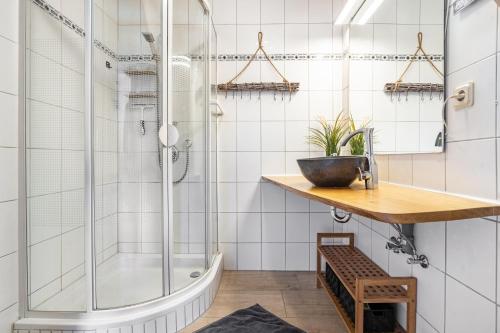 a bathroom with a shower and a wooden counter at Ferienwohnung Wulf in Groß Zicker